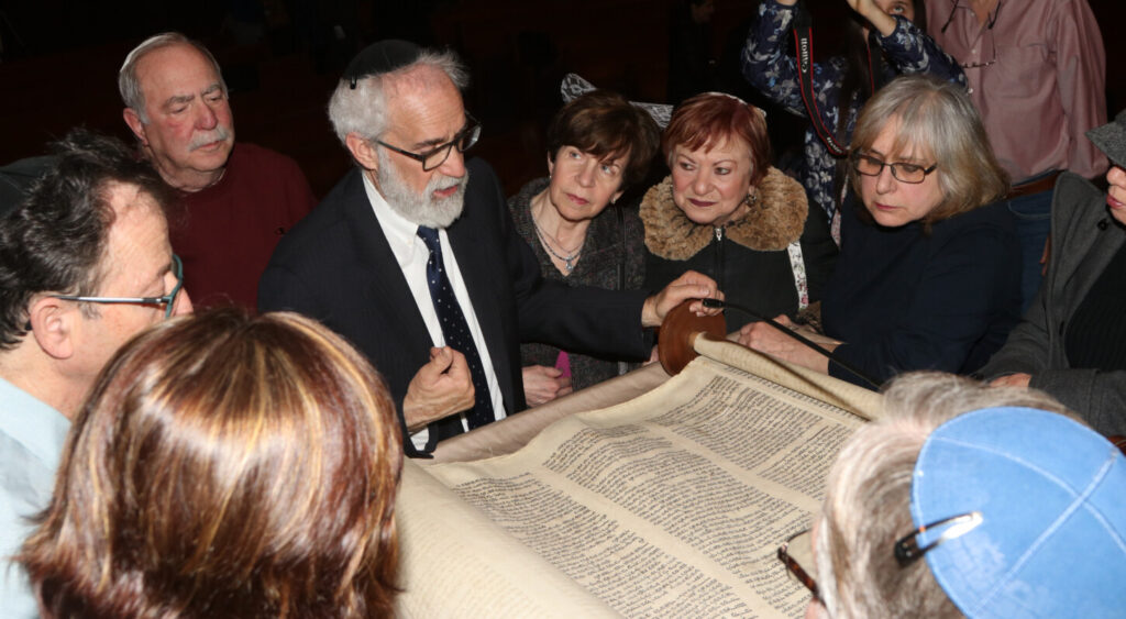 Rabbi Androphy reads from one of our Holocaust Torahs